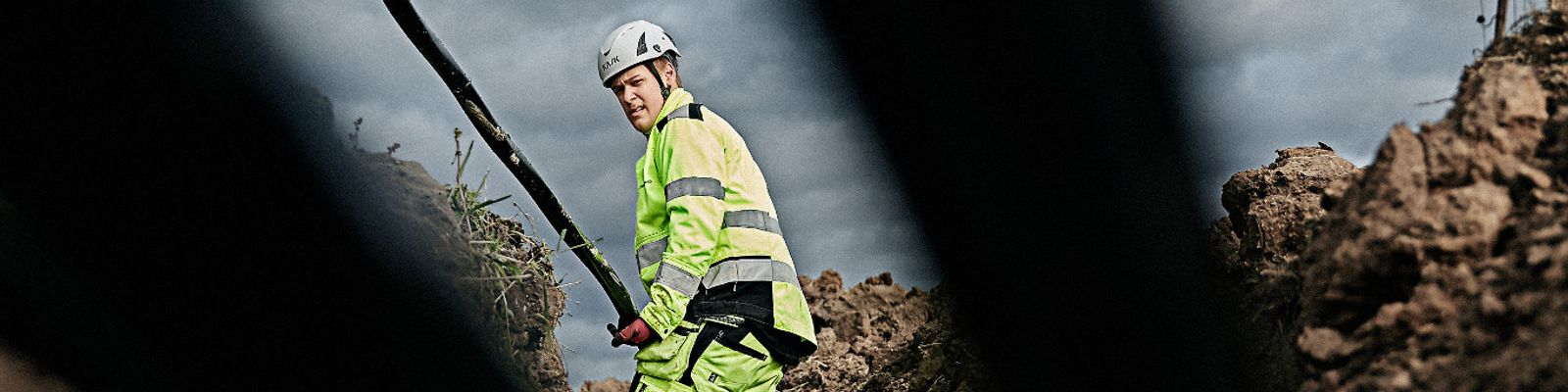 Cable worker laying Axal-TT medium voltage cable in the ground